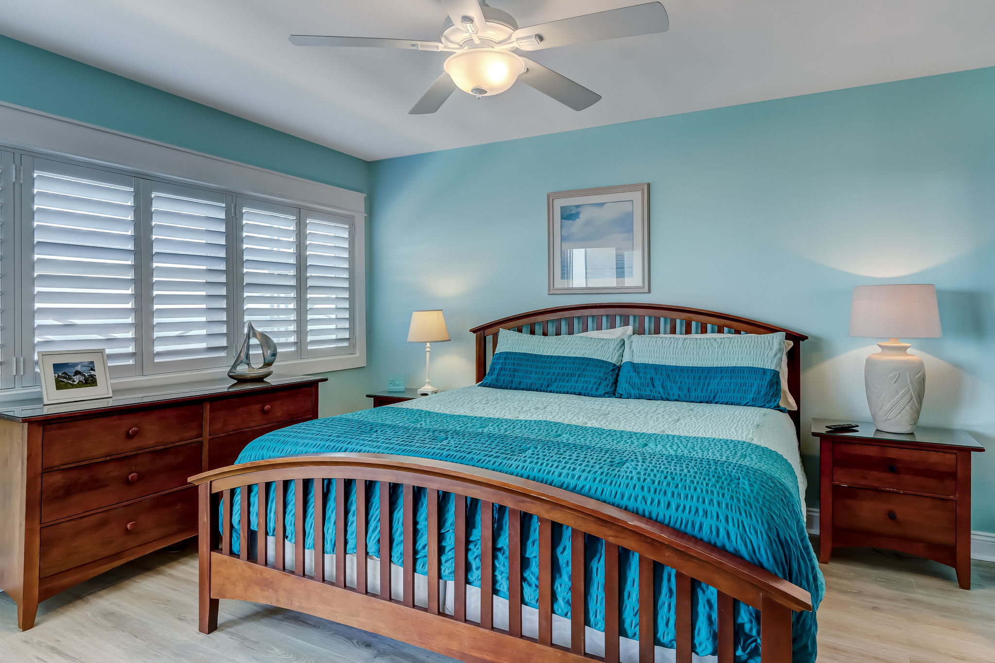 Bedroom with plantation shutters and king bed